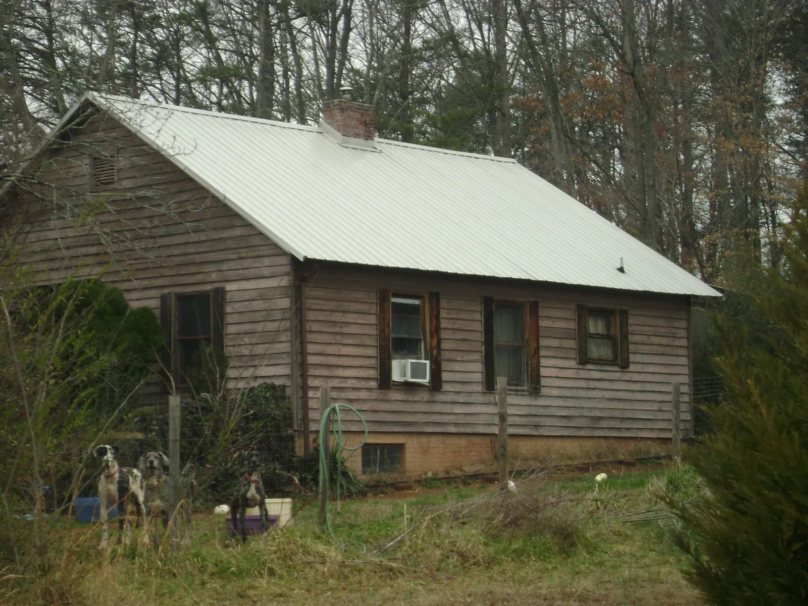 White metal roof on an old wood sided farmhouse, from a Metal Roof Installation job in New Lothrop